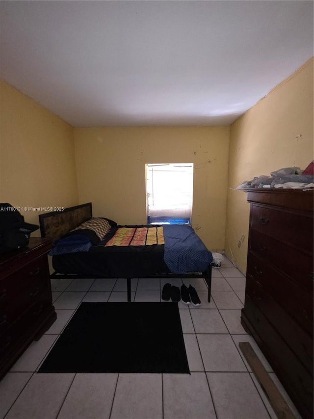 bedroom featuring light tile patterned flooring