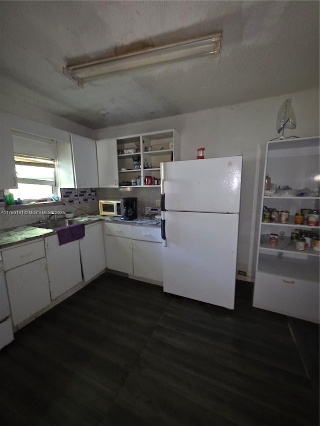 kitchen with white appliances, open shelves, dark wood-style flooring, decorative backsplash, and white cabinets