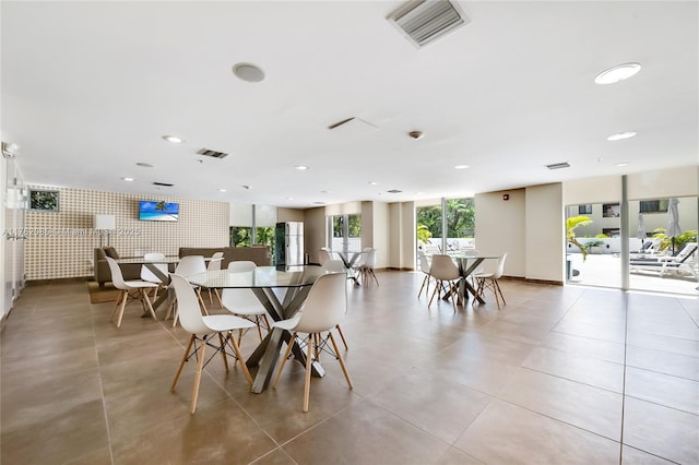 tiled dining area with visible vents, recessed lighting, baseboards, and expansive windows