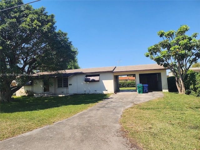 ranch-style house with an attached carport, concrete driveway, and a front lawn