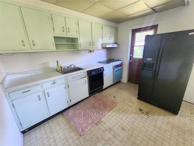 kitchen with black appliances, light floors, under cabinet range hood, and a sink