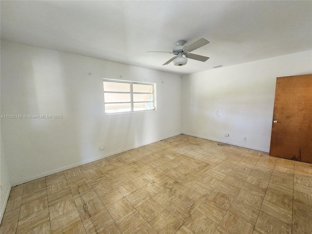 unfurnished room featuring visible vents, baseboards, and ceiling fan