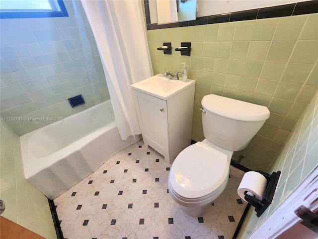 bathroom featuring vanity, shower / bath combination with curtain, tile walls, toilet, and tile patterned floors