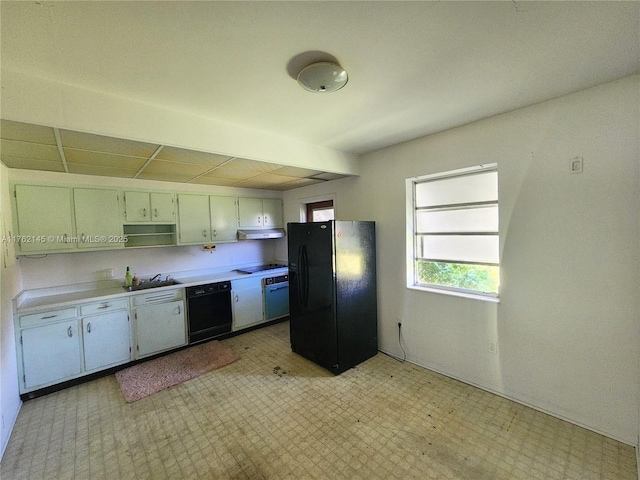 kitchen featuring black appliances, under cabinet range hood, a sink, light countertops, and light floors