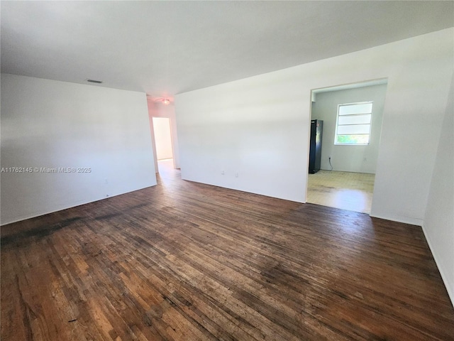 spare room with wood finished floors