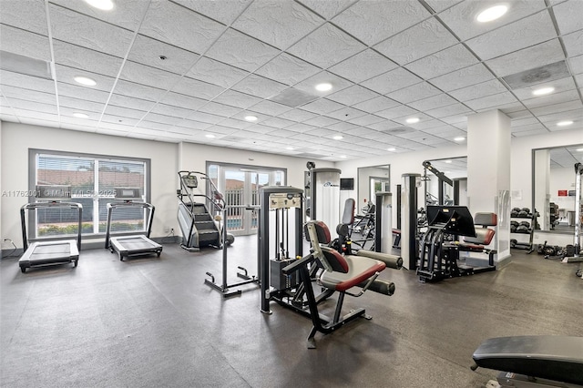 gym with recessed lighting, a paneled ceiling, and baseboards