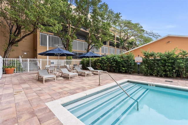 view of pool featuring a patio area and fence