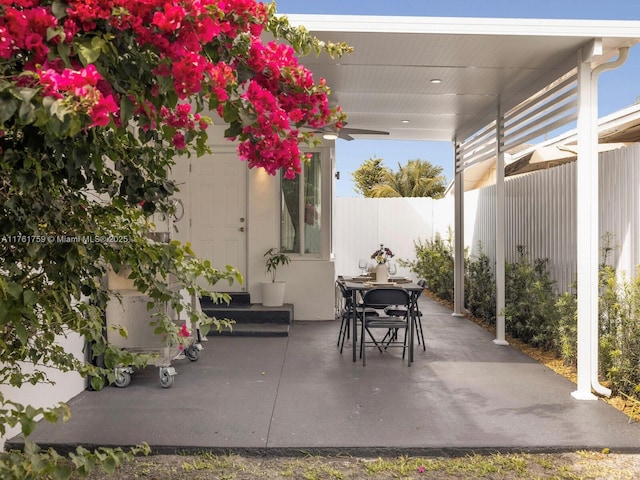 view of patio with outdoor dining space and fence