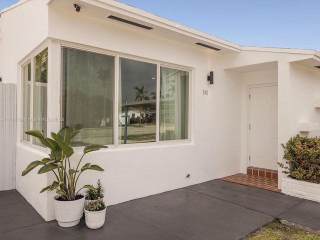 entrance to property with stucco siding