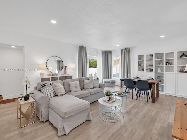 living area with recessed lighting and light wood-style flooring