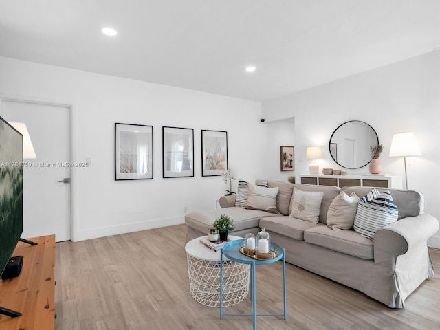 living area featuring light wood-style flooring, recessed lighting, and baseboards