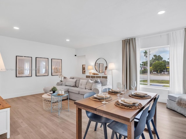 dining room with recessed lighting, light wood-type flooring, and baseboards