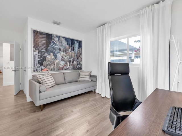 office featuring visible vents and wood finished floors