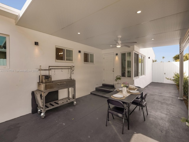 view of patio with entry steps, a ceiling fan, and fence