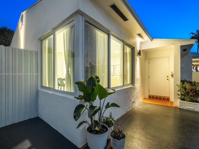 exterior space featuring fence and stucco siding