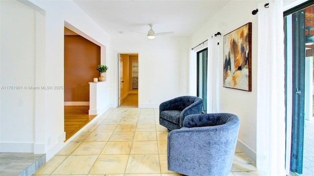 interior space featuring a ceiling fan and baseboards