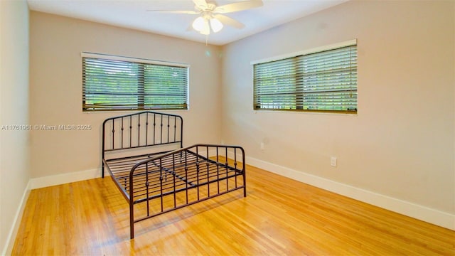 bedroom with wood finished floors and baseboards