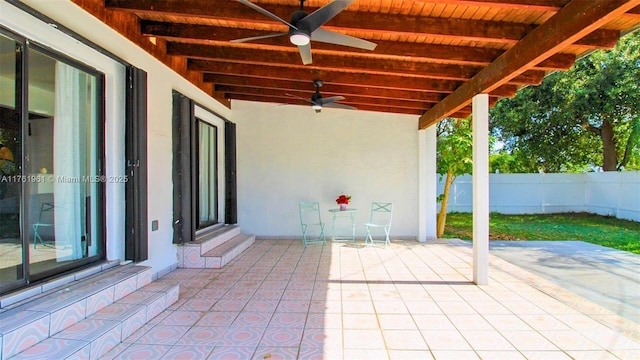 view of patio / terrace with a ceiling fan and fence