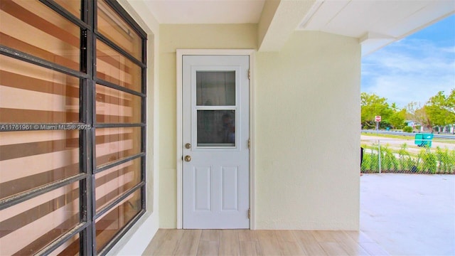 view of exterior entry featuring stucco siding