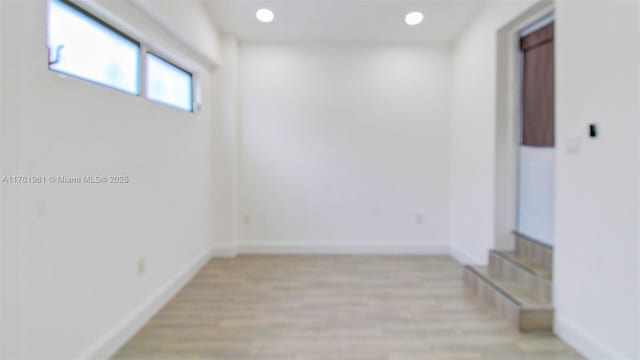 unfurnished room featuring recessed lighting, baseboards, and light wood-style floors