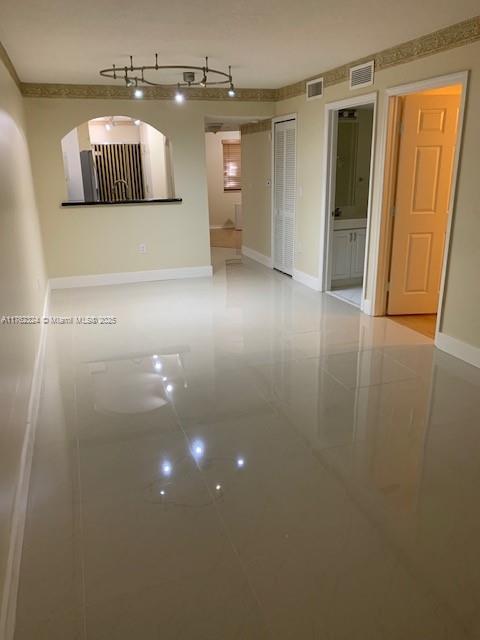 unfurnished room featuring baseboards and visible vents