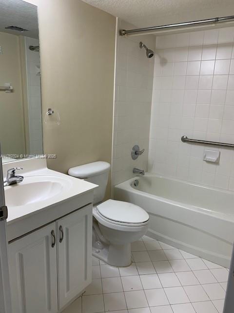 full bath featuring vanity, a textured ceiling, shower / bathing tub combination, toilet, and tile patterned floors