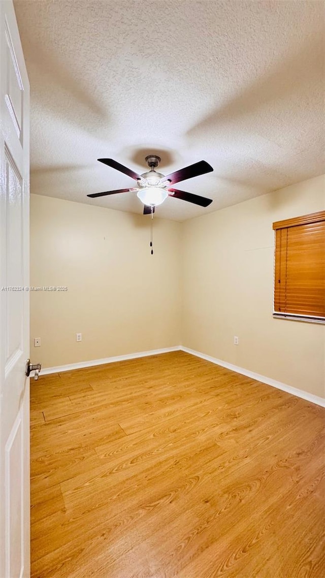 1260 SE 31st Ct Unit 102-34, Homestead, FL 33035 - spare room featuring light wood-type flooring, ceiling fan, and baseboards