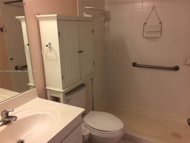 full bath with a stall shower, toilet, and vanity