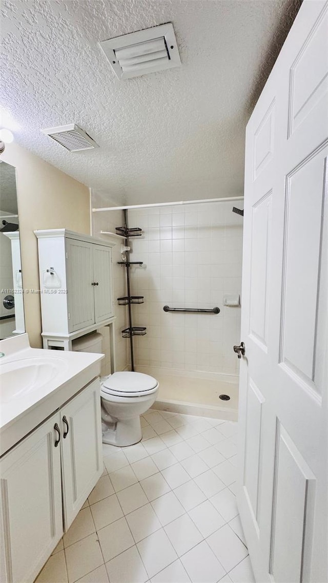 1260 SE 31st Ct Unit 102-34, Homestead, FL 33035 - bathroom featuring vanity, tile patterned floors, toilet, tiled shower, and visible vents