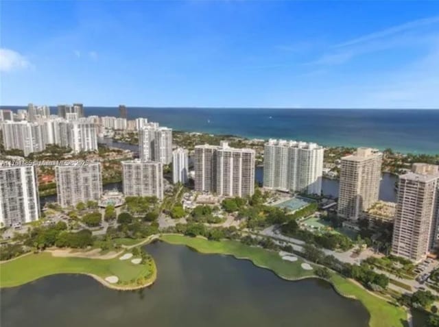 drone / aerial view featuring a view of city and a water view