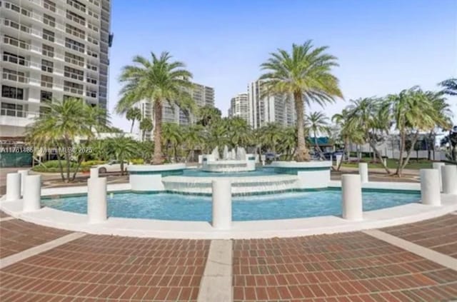 view of pool with a city view