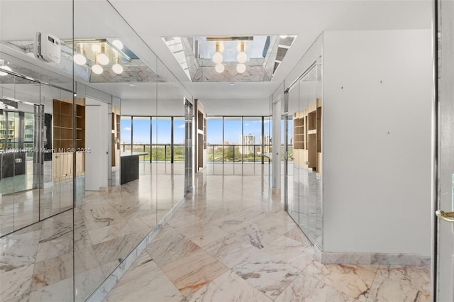 hall with a wall of windows and marble finish floor