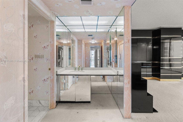 bathroom featuring vanity, visible vents, and marble finish floor