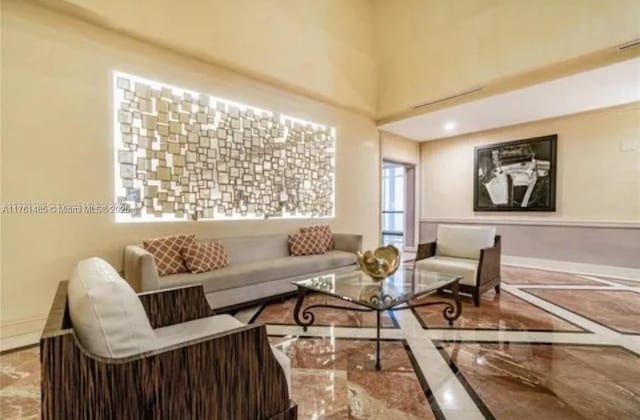 living room featuring baseboards and marble finish floor