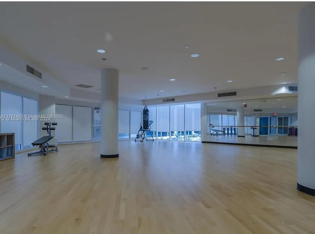 gym with recessed lighting, wood finished floors, and visible vents