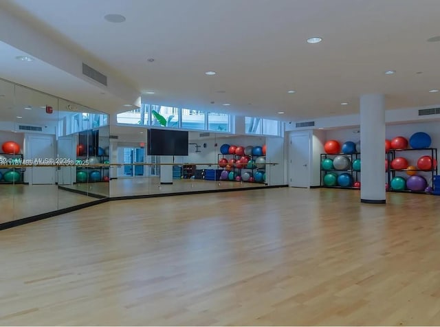 exercise room featuring visible vents and wood finished floors