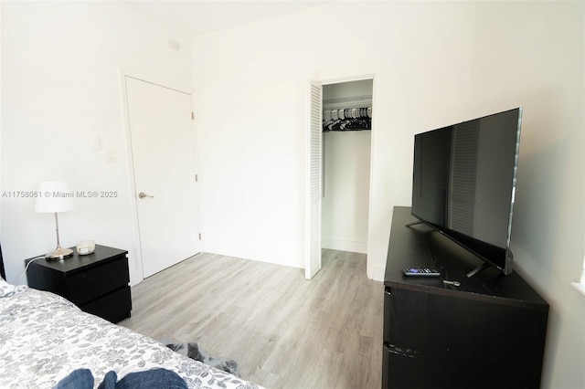 bedroom featuring a closet and light wood-style flooring