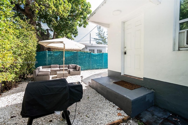 view of patio with grilling area, an outdoor hangout area, and a fenced backyard