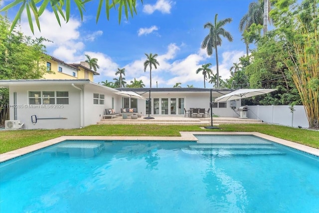 952 Hollywood Blvd, Hollywood, FL 33019 - rear view of house featuring a fenced in pool, fence, stucco siding, a yard, and a patio area