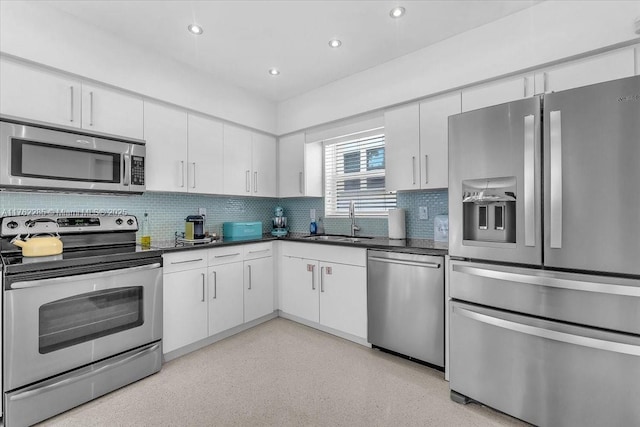 952 Hollywood Blvd, Hollywood, FL 33019 - kitchen featuring dark countertops, white cabinets, stainless steel appliances, and a sink