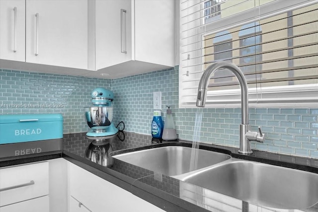 952 Hollywood Blvd, Hollywood, FL 33019 - interior details with a sink, backsplash, dark countertops, and white cabinets