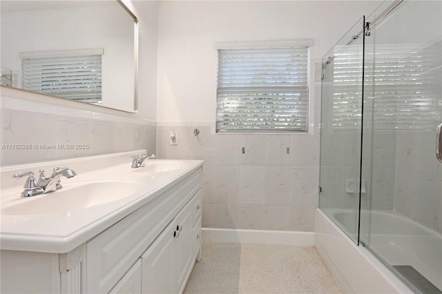 952 Hollywood Blvd, Hollywood, FL 33019 - bathroom with a wainscoted wall, tile walls, speckled floor, and a sink