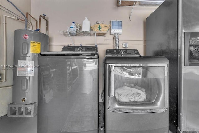 952 Hollywood Blvd, Hollywood, FL 33019 - clothes washing area with laundry area, washer and dryer, and electric water heater