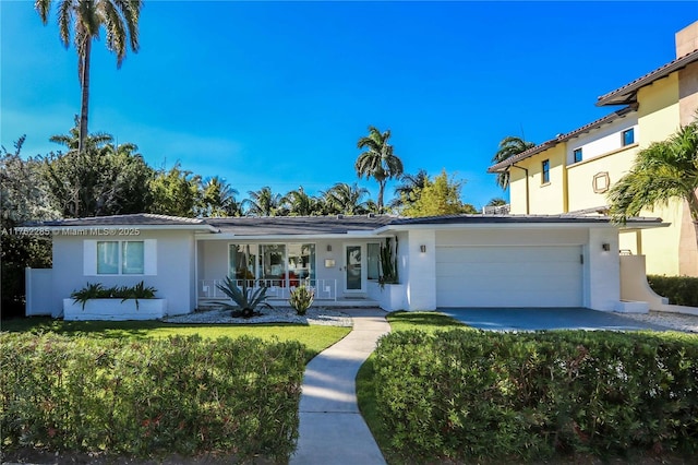 952 Hollywood Blvd, Hollywood, FL 33019 - view of front of home featuring a front yard, a garage, covered porch, and stucco siding