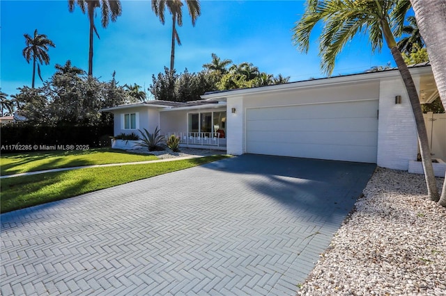 952 Hollywood Blvd, Hollywood, FL 33019 - single story home with an attached garage, decorative driveway, and a front yard