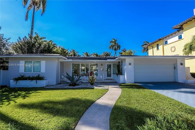952 Hollywood Blvd, Hollywood, FL 33019 - ranch-style house featuring an attached garage, a front lawn, covered porch, stucco siding, and driveway