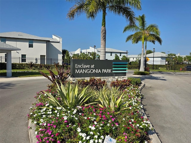 community / neighborhood sign featuring fence