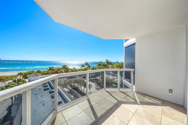 balcony with a beach view and a water view