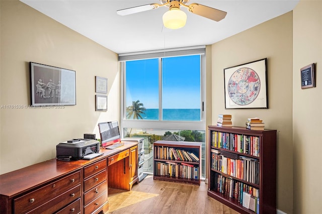 office area with ceiling fan and light wood-style floors