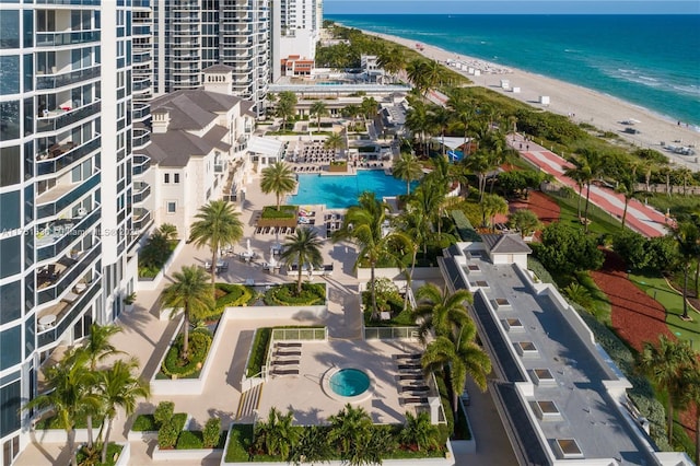 bird's eye view with a water view and a beach view